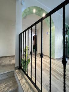 a staircase with black railings and an archway in a house at VittoNico in Morcone