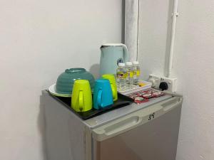 a toy refrigerator with a tray on top of it at Padang Besar Roomstay Firdaus in Padang Besar