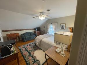 a bedroom with a bed and a couch at Dodds Brick House Bed & Breakfast in North Hero