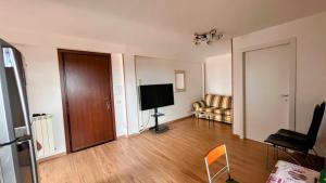 a living room with a television and a couch at Oasi di Serenità in Marino