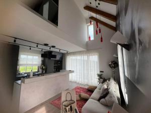 a living room with a couch and a kitchen at Villa Lavender in Felsőörs