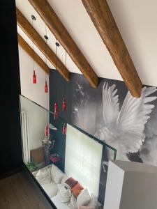 a room with a wall with a mural of a bird at Villa Lavender in Felsőörs