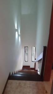 a hallway with stairs and a stair case with windows at Brisa do Mar Village in Salvador