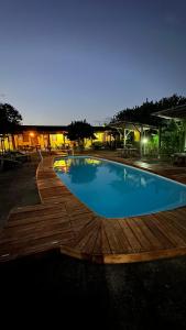 a large swimming pool with a wooden deck at Hotel Urumajó in Augusto Correa