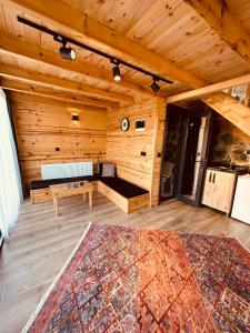 a wooden room with a bench and a rug on a floor at Greenlife Dağevleri in Rize