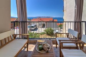 a balcony with two chairs and a table with a view at Apartment Tera in Senj