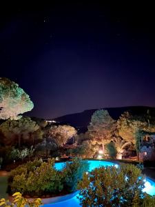a view of a swimming pool at night at Hôtel Ambassador Palombaggia in Porto-Vecchio