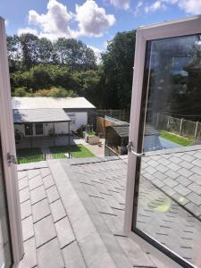 an open door to a patio with a view of a house at Private room in Wrexham