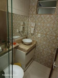 a bathroom with a sink and a toilet at Florcamará POUSADA in Camaragibe +63 photos