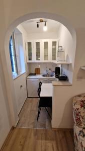 a kitchen with an archway over a kitchen sink at Apartment Melody in Dubrovnik