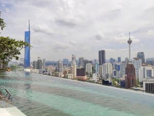 a swimming pool with a view of a city at Axon Residences Bukit Bintang in Kuala Lumpur