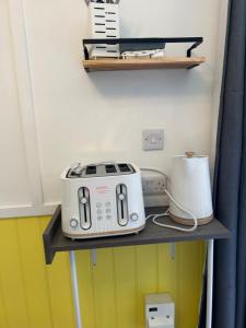 a toaster sitting on a shelf in a kitchen at 1Lochness glam lodges in Inverness