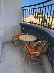 two chairs and a table on a balcony at C.leslie_homes2 in Bamburi