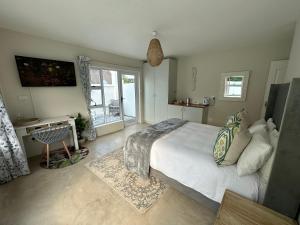 a bedroom with a large bed and a window at Adrift Guesthouse St Francis Bay in St Francis Bay