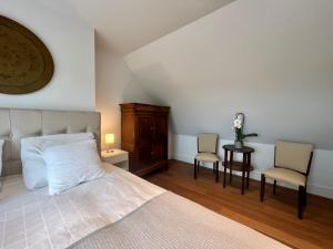 赫爾的住宿－Luxury Business Accommodation Geel，一间卧室配有一张床和两把椅子