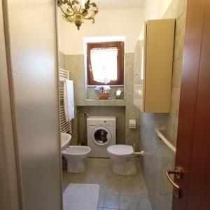 a bathroom with a toilet and a sink at La Casetta in Treglio +24 photos