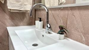 a white bathroom sink with a faucet on it at Cozy 2 bedroom apartment in Nahariya in Nahariyya