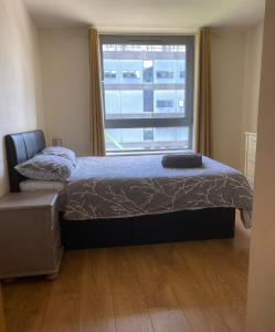 a bedroom with a bed and a large window at The Cube Side Apartments - One Bedroom With Balcony in Birmingham