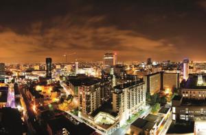 a view of a city at night at The Cube Side Apartments - One Bedroom With Balcony in Birmingham
