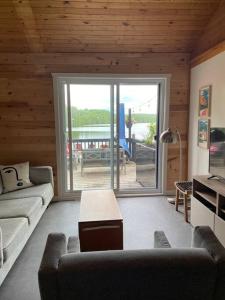 a living room with a couch and a table at Willow Cabin- North Frontenac Lodge in Ompah