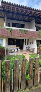 a wooden fence in front of a house at Brisa do Mar Village in Salvador