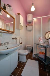 a bathroom with a sink and a toilet at La Casina di Sarteano in Sarteano