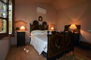 a bedroom with a large bed with two lamps at La Casina di Sarteano in Sarteano