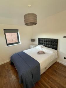 um quarto com uma cama grande e uma janela em 3 bedroom home in Nottage, Porthcawl em Nottage