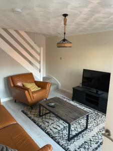 a living room with a couch and a coffee table at 3 bedroom home in Nottage, Porthcawl in Nottage