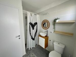 a bathroom with a white toilet and a sink at Ein Hod - Artists Village in Ein Hod