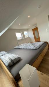 a bedroom with a large bed in a attic at Moderne Dachgeschosswohnung Modern Apartment in Rastatt