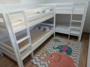 a room with two bunk beds and a rug at Spacious, comfortable and peaceful house in Međugorje