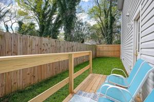 a patio with a blue chair and a fence at DT/2 Spacious 3BR Suites/FreeParking/SelfCheckin in Raleigh