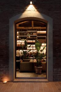 a room with a window with a couch and a plant at Borgo Dolciano in Chiusi