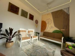 a living room with a couch and chairs in it at Boho - By Great Impressions in Pune