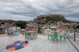 a table and chairs on a balcony with a view at Banaji Heritage Haveli in Jodhpur