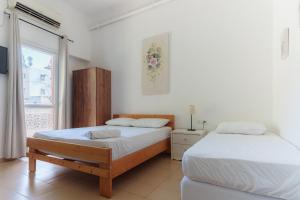 Postel nebo postele na pokoji v ubytování Hotel Loui Talpiot