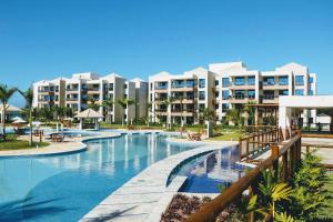 a resort swimming pool with buildings in the background at Apto 3 quartos no Wai Wai - Cumbuco-Ce in Cumbuco