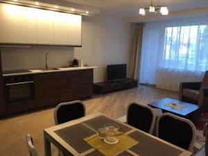 a living room with a table and a kitchen at Spacious Apartment in Kintai in Kintai