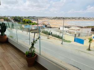 a view of a street from a balcony with plants at Appartement en bord de mer in Pont Blondin