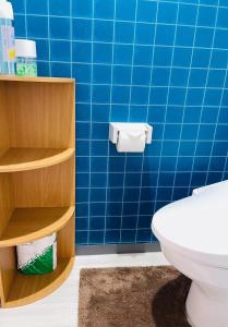 a bathroom with a blue tiled wall and a toilet at 心斎橋、道頓堀徒歩10分！難波、黒門市場、徒歩圏内の最高の立地 in Osaka