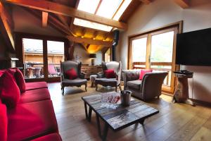 a living room with a red couch and chairs and a table at Prestigious 18 Person Chalet with Pool and Jacuzzi in Vars