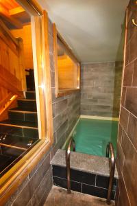 a hot tub in a room with a staircase at Prestigious 18 Person Chalet with Pool and Jacuzzi in Vars