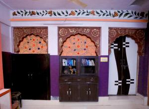a room with two crosses on the wall and a tv at Banaji Heritage Haveli in Jodhpur