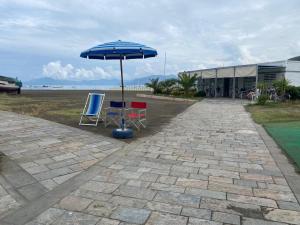 two chairs and an umbrella in front of a building at Central Sestri Executive 2 Bedroom&Huge Terrace in Sestri Levante