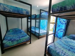 a room with three bunk beds and a window at Freedom​ Hostel​ in Khao Lak