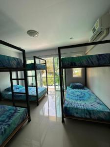 a room with three bunk beds in it at Freedom​ Hostel​ in Khao Lak