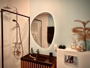 a bathroom with a sink and a mirror at Apartament CZOS in Mrągowo