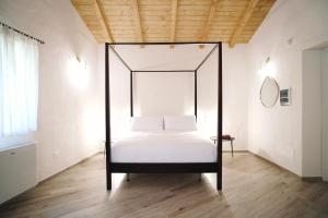 a bed with a black frame in a room at Casa Marinari in Scalea