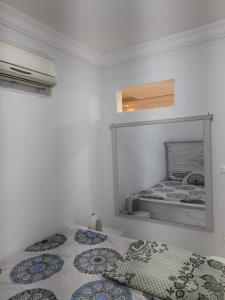a bedroom with two beds and a mirror at Golf porto marina apartment, El Alamein in El Alamein +27 photos